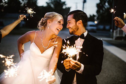 Bride and groom exit with sparkles