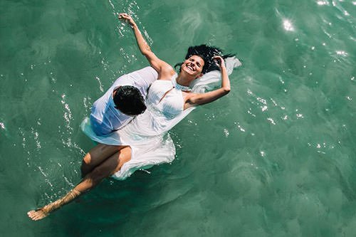 bride and groom in the water