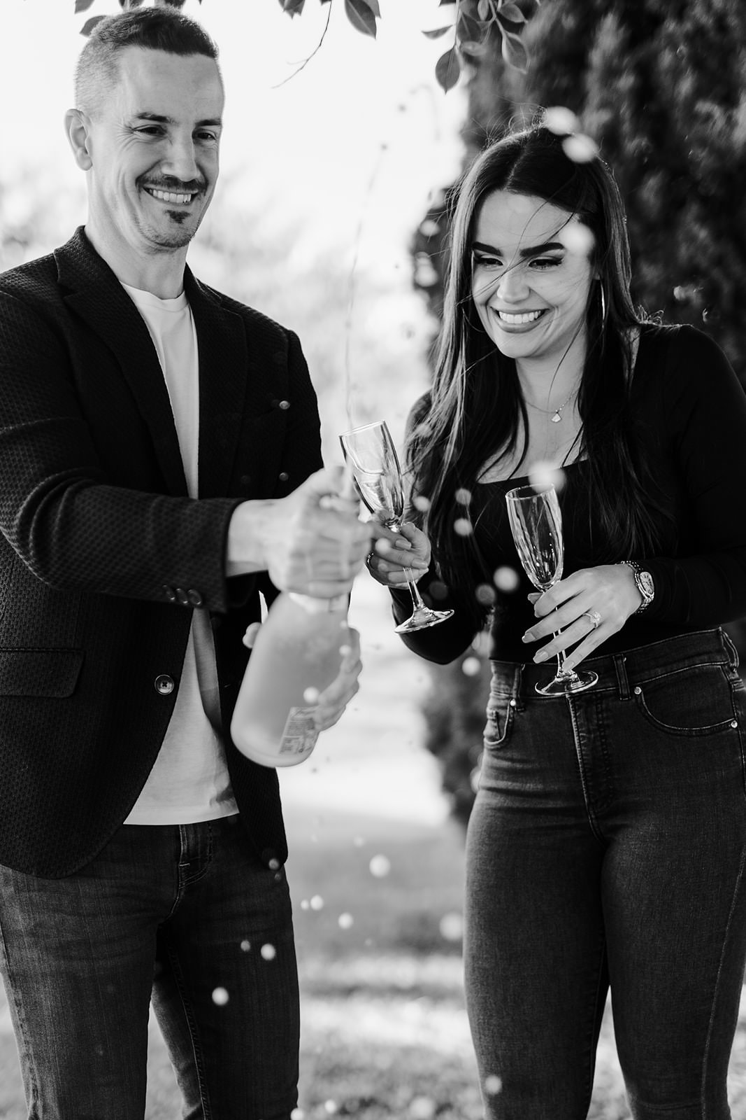 couple celebrating engagement with champagne