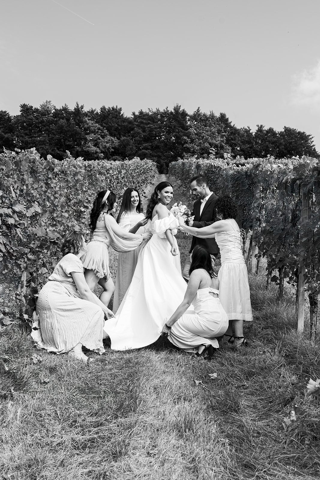 Bride posing solo in a vineyard near her preparation house before the ceremony, wearing her wedding dress and radiating elegance