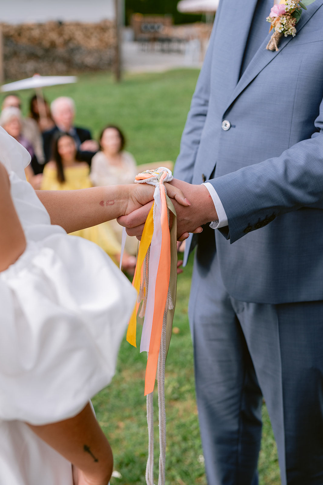 Newlyweds celebrating joyfully under the beautifully decorated ceremony tree at their vineyard wedding in Austria