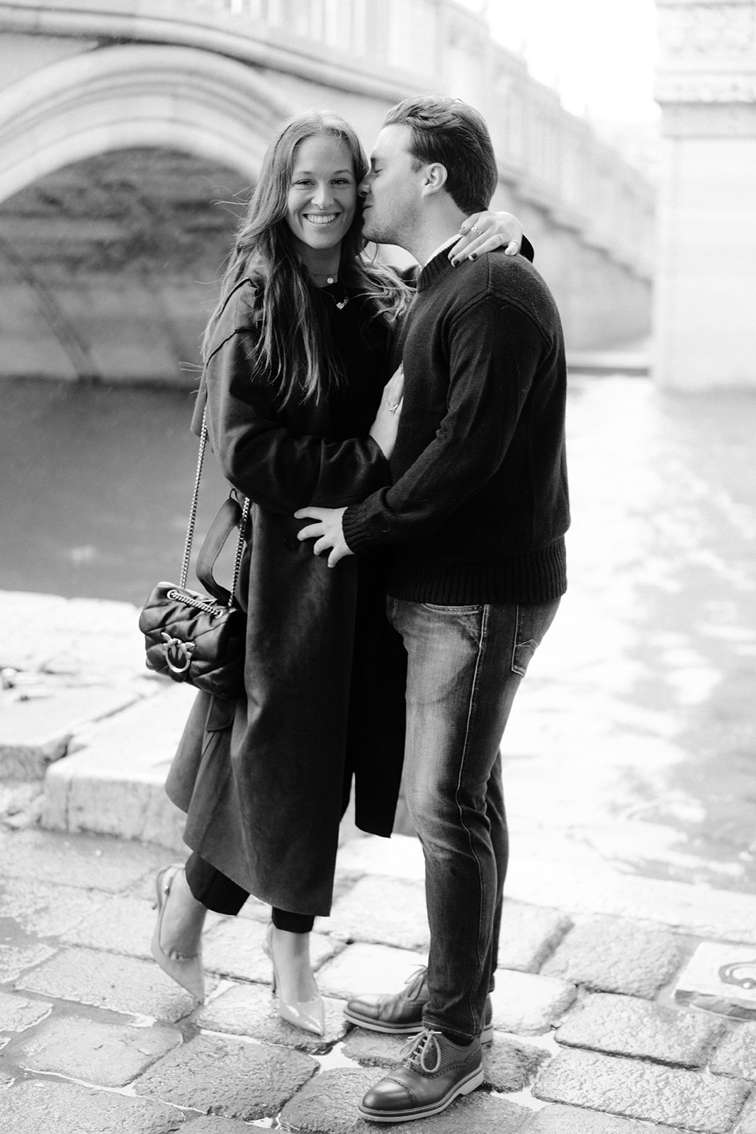 Couple walking through Venetian alley during engagement session