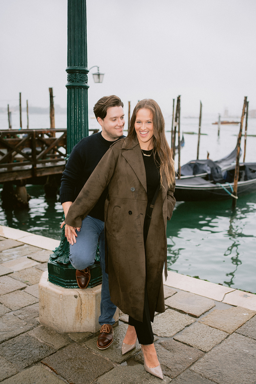 Couple portrait in Venice wearing winter coats