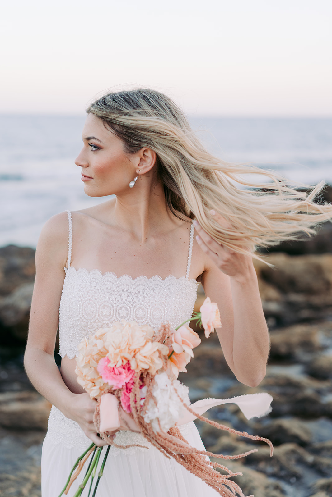 Bride walking by the sea in wedding dress